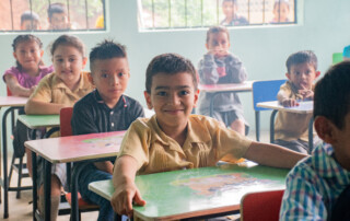 Guatemalan student at desk in classroom