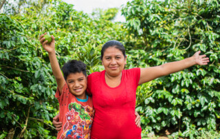 Mother and son celebrate a in coffee field